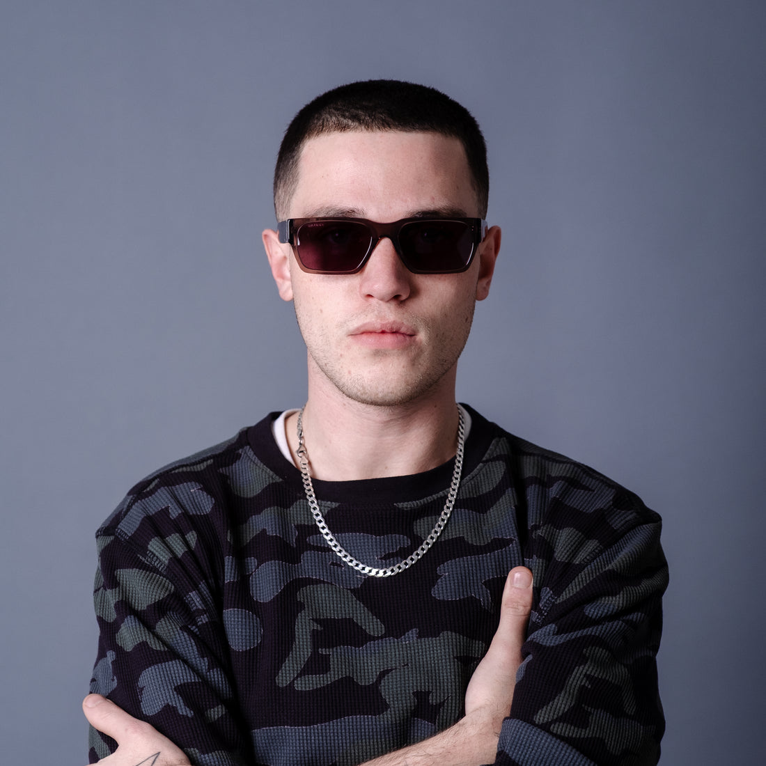 Sunglasses with a purple lens and transparent frame on a white background